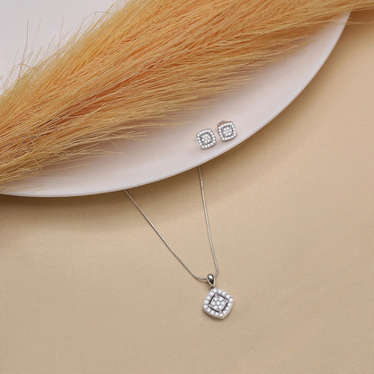 This is a silver-toned cushion-cut crystal pendant necklace with cubic zirconia and matching stud earrings