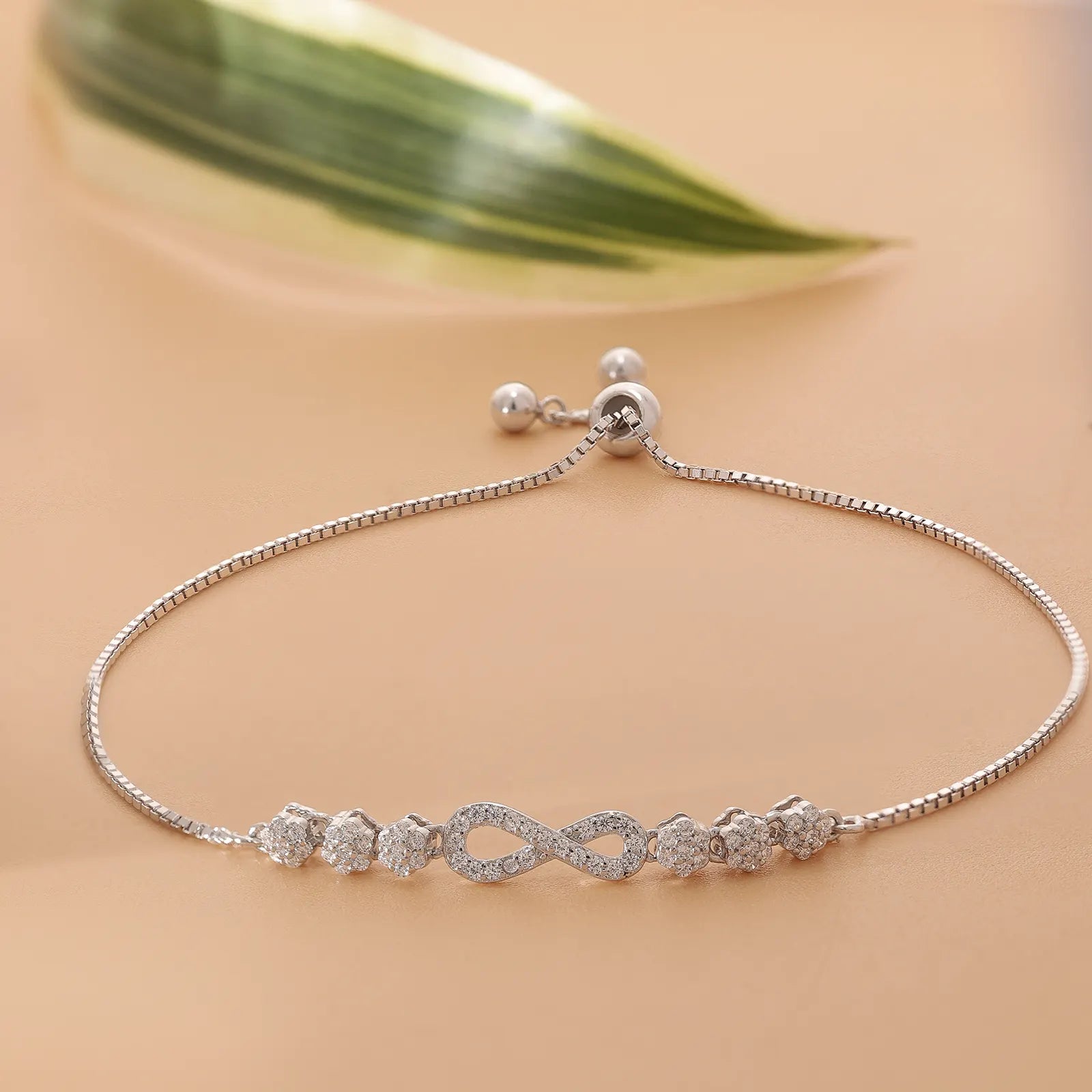 This is a silver-toned infinity bolo bracelet with cubic zirconia accents.